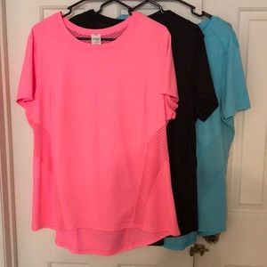 Three Danskin athletic workout tops.
